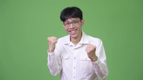 young happy asian businessman smiling and excited