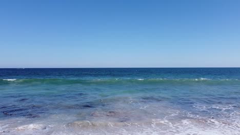 the indian ocean tide rolling into burns beach in western australia, slow motion