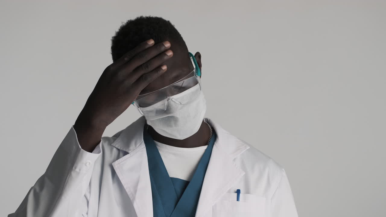 African american doctor on grey background.