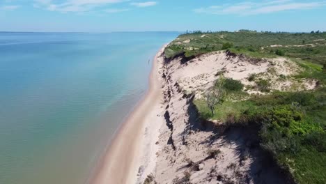 aerial beachline and sand dune fly along