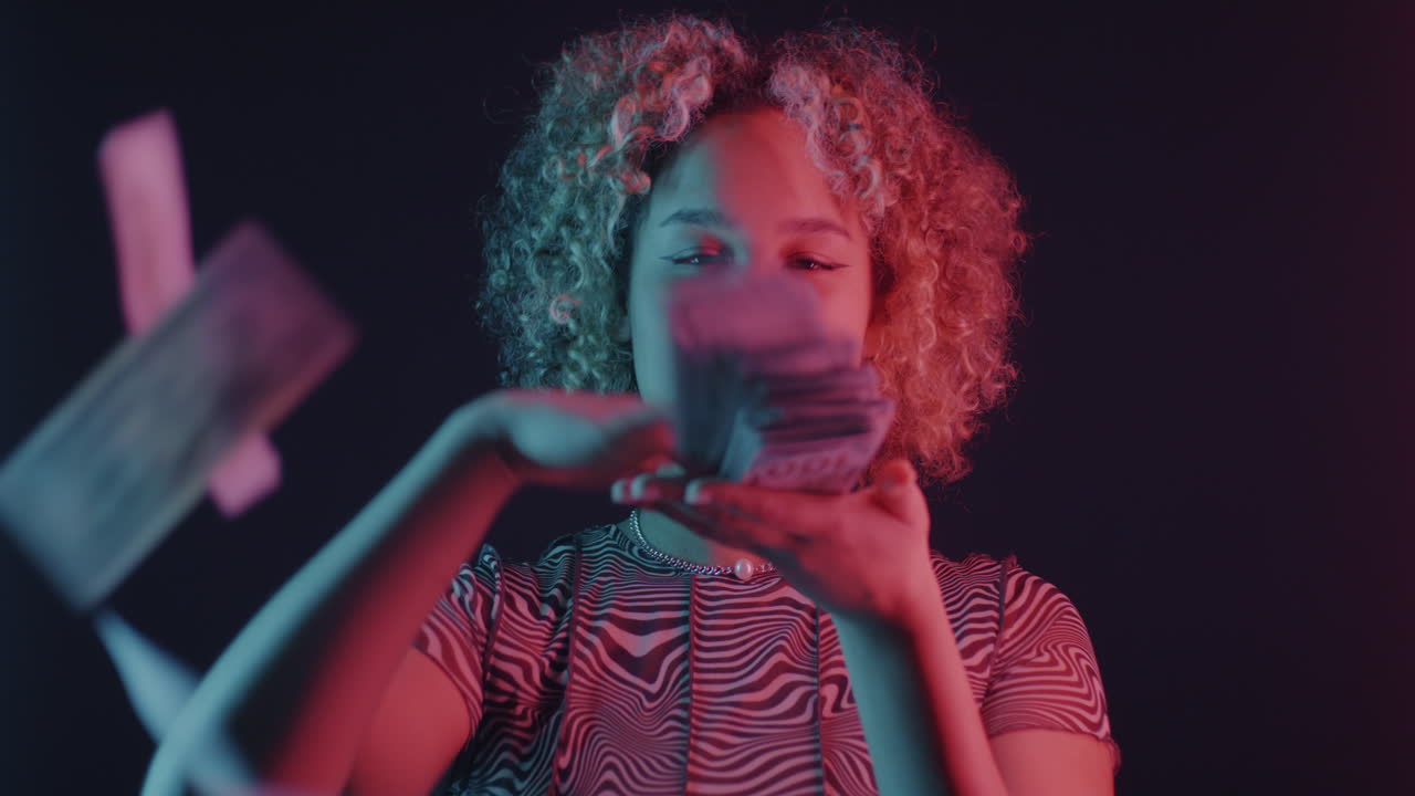 Woman Holding Money Under Neon Lights