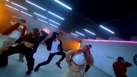 energetic dance crew performance in neon lit studio