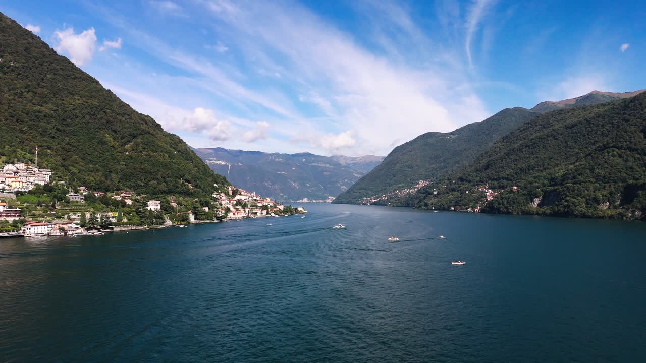 Fly forward downwards Lake Como, lots of boats in the water