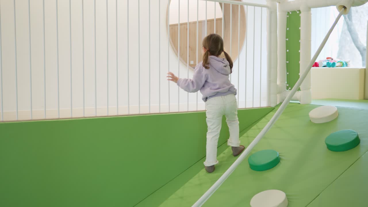 Toddler Girl Playing on Indoor Playground