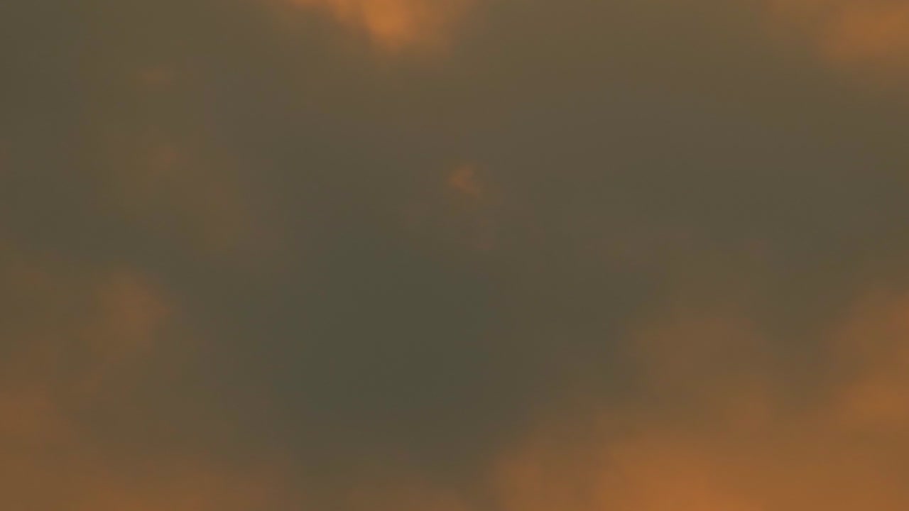 Turbulent beauty: red sun piercing through heavy black clouds in Bangladesh's atmosphere