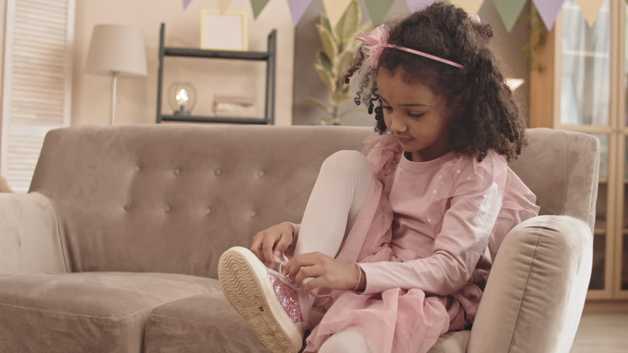 Little Girl Trying Lacing Shoe