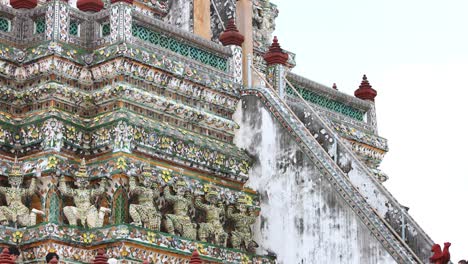 visitors admire wat arun's detailed mosaic designs