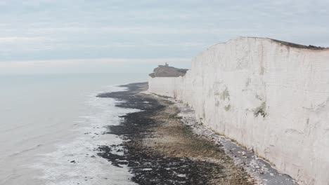 long drone shot towards belle tout light house along white cliffs uk