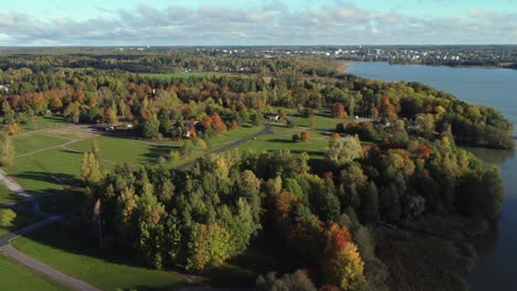 Flyover colorful autumn lakeside properties near Kerava, Finland