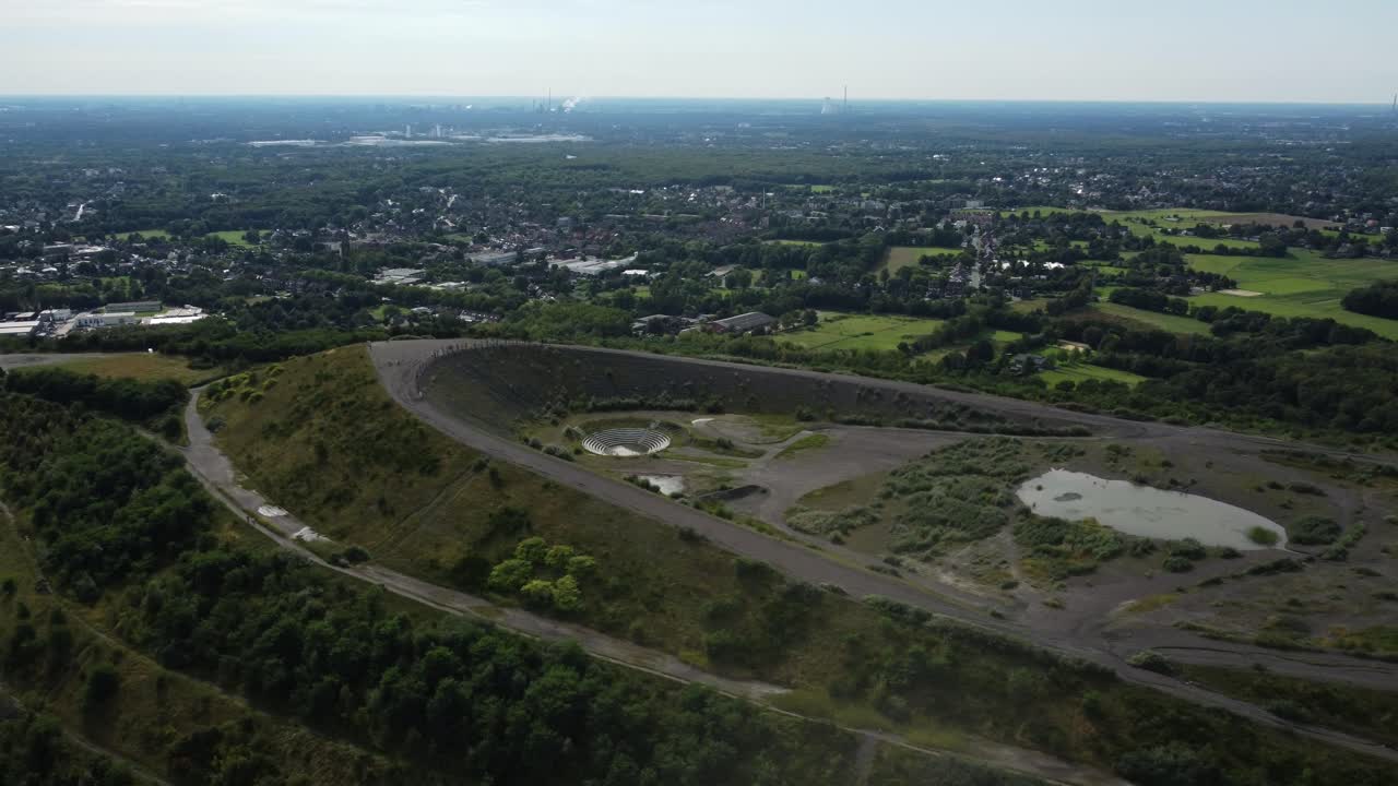 Aerial view of a landscape with a hill and lake