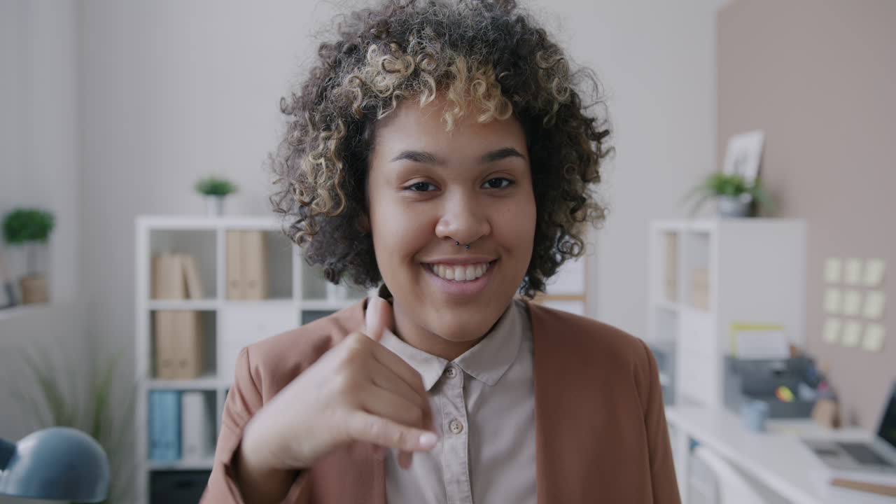 Smiling Woman Pointing in Office Setting