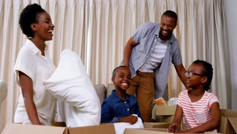 Parents-and-kids-opening-cardboard-boxes-in-living-room