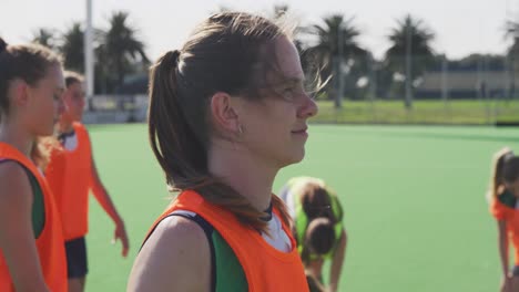 Female-hockey-players-exercising-on-the-field