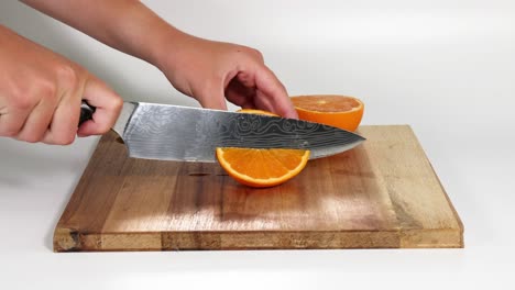 sequential steps of cutting an orange into slices