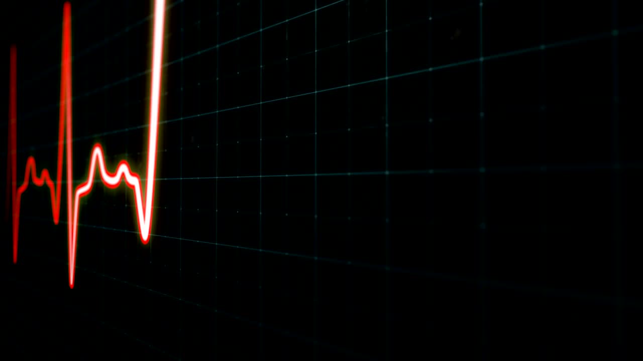 Red heartbeat line with white core, EKG screen in close-up