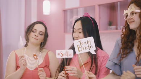 close up view of four  women with headdresses and holding cardboard phrases 1