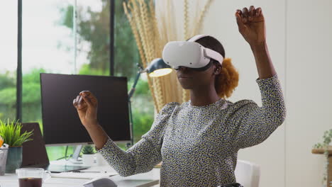 woman working from home office at desk interacting with ar technology