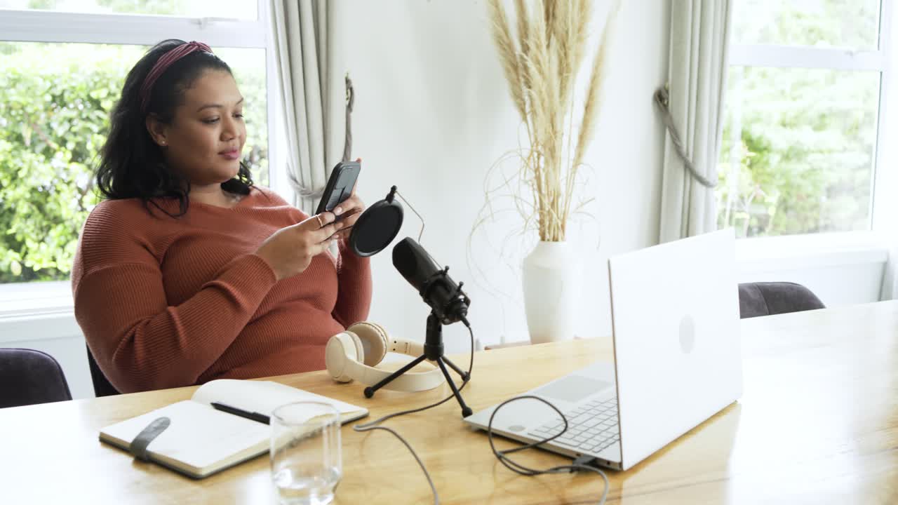Happy Woman Using Smartphone While Setting Up Podcast Recording