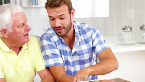 A-family-talking-and-showing-their-tablet