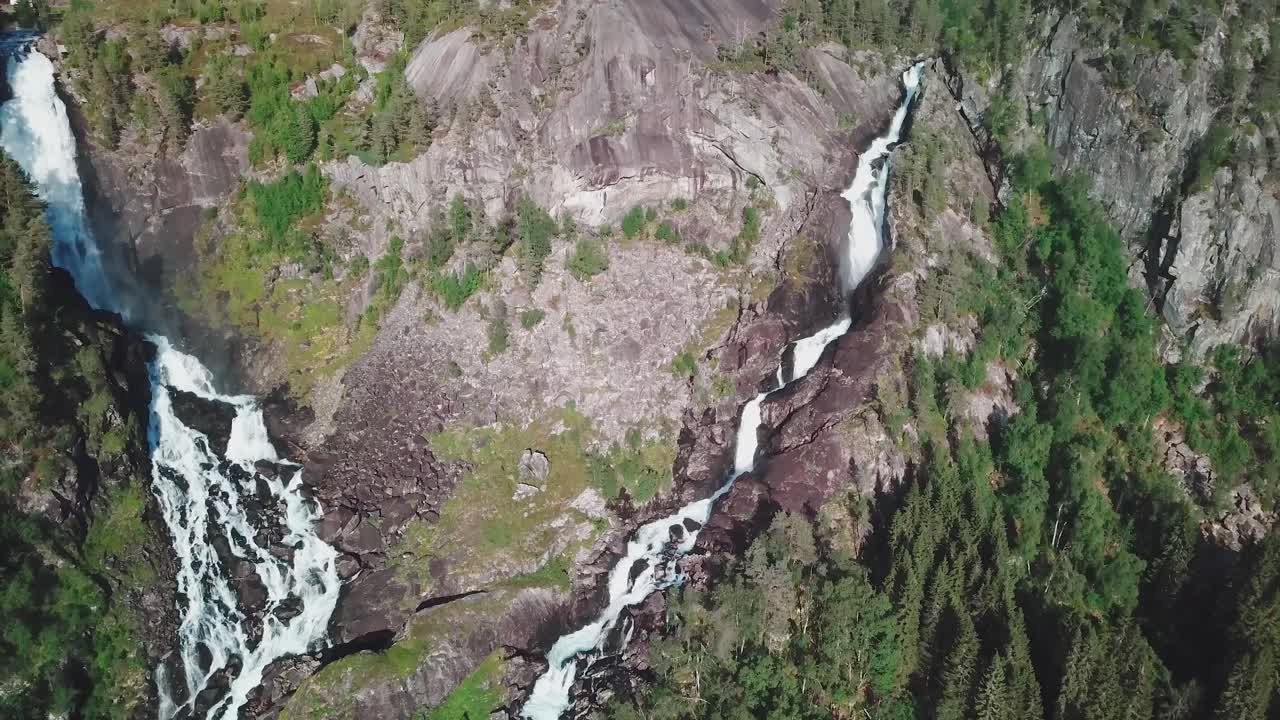 hacia atrás, un dron inclinado hacia arriba disparó sobre dos grandes cascadas en noruega, filmado en 4k
