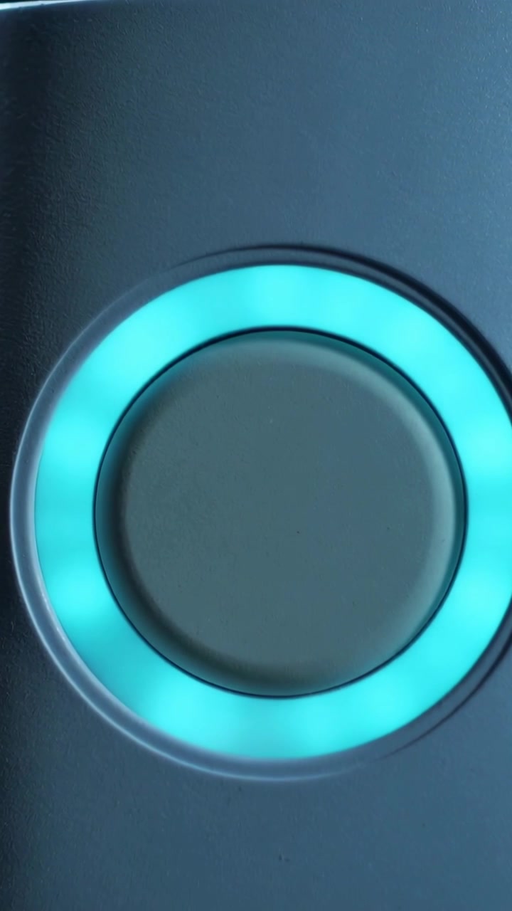 Vertical video: Powering on circular LED ring with center cap glowing cyan on panel showing standby
