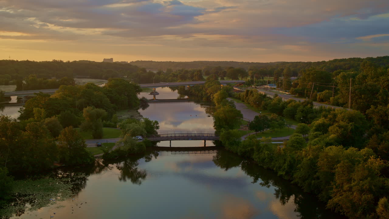Drone footage with a slow, sweeping view of the Huron River in Ann Arbor, Michigan, in summer.