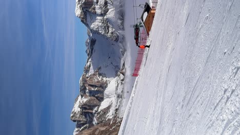 Person-skiing-down-a-snowy-mountain-pass,-Seceda,-Dolomites
