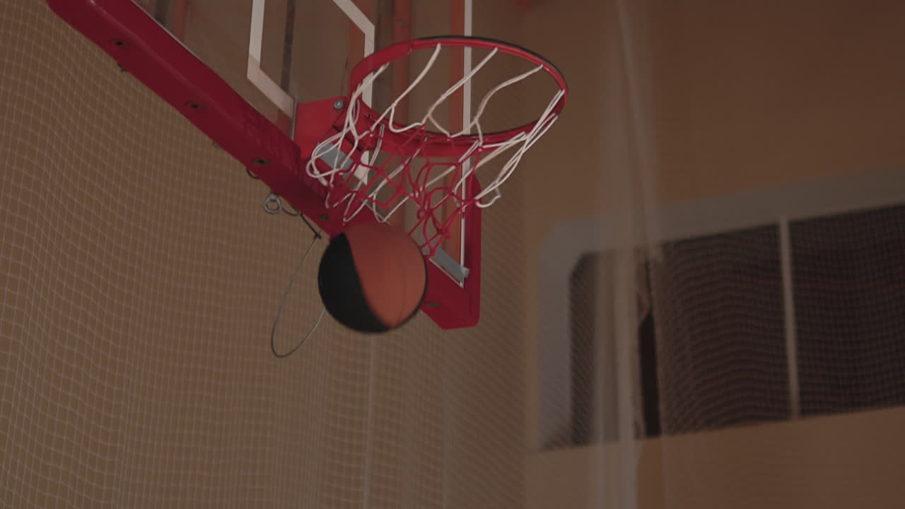 Slowmo of Happy Player Helping Son Shoot Basketball