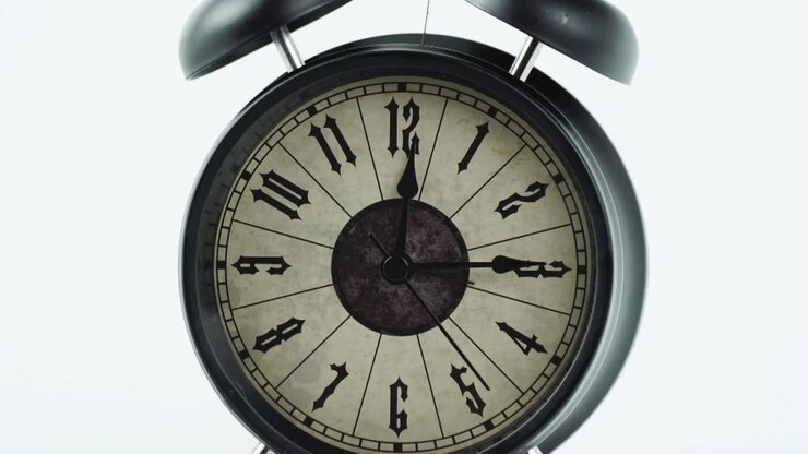 Time lapse black alarm clock tell the time 12:37 minute.