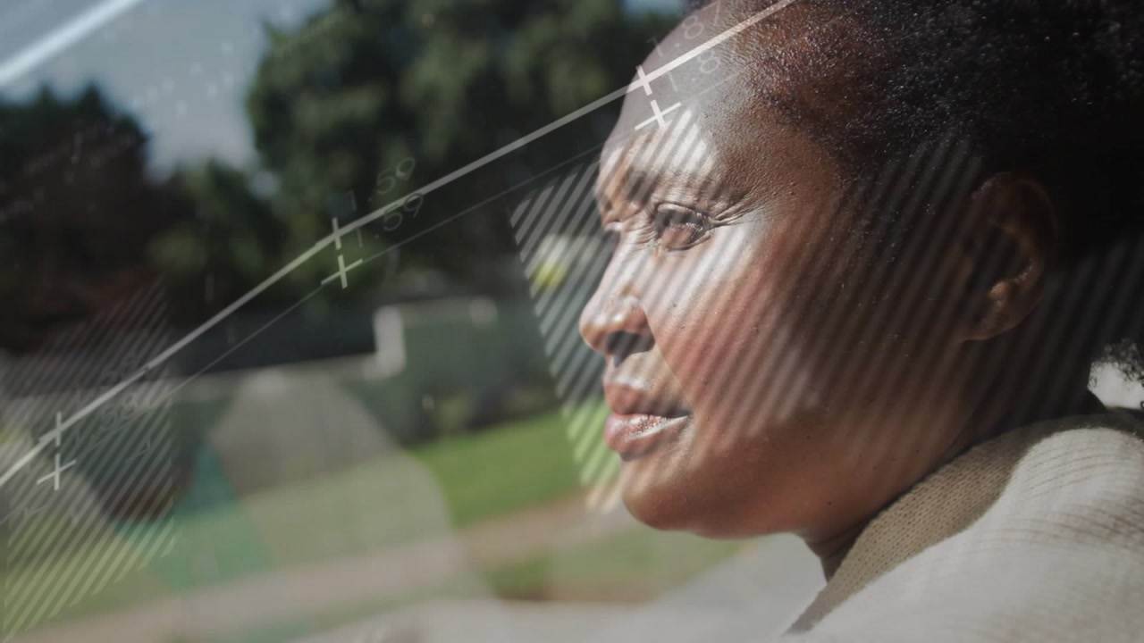 woman gazing into yard while feed unfolding, tech overlay projecting graphs shapes code onto pane