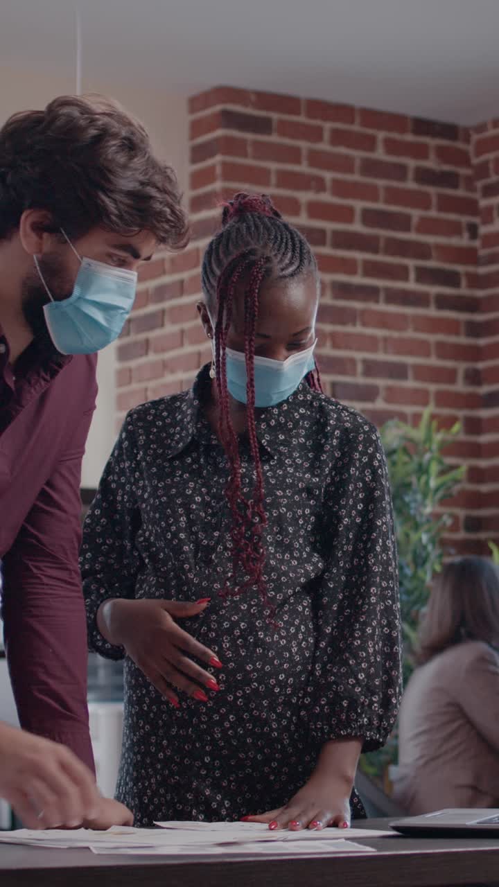 People working in office wearing face masks