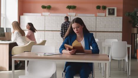 young woman reading in library