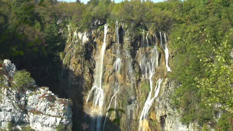 Wide-angle-view-of-the-tall,-thin-waterfalls-of-Veliki-Slap-in-Plitvice-Lakes-National-Park-in-Croatia,-Europe-at-¼-speed