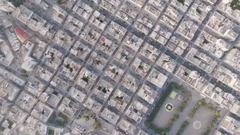 top down aerial footage rotating showing the buildings of downtown monopoli, italy during the early morning