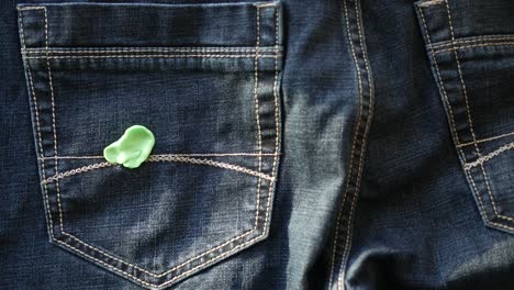 green gum in jeans back pocket