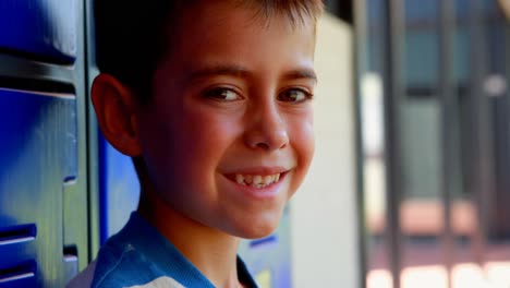 Portrait-of-happy-schoolboy-standing-in-locker-room-4k