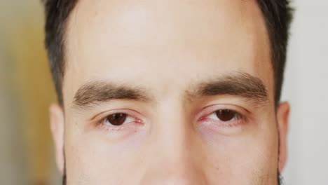 Video-close-up-portrait-of-the-eyes-of-smiling-caucasian-man,-with-copy-space