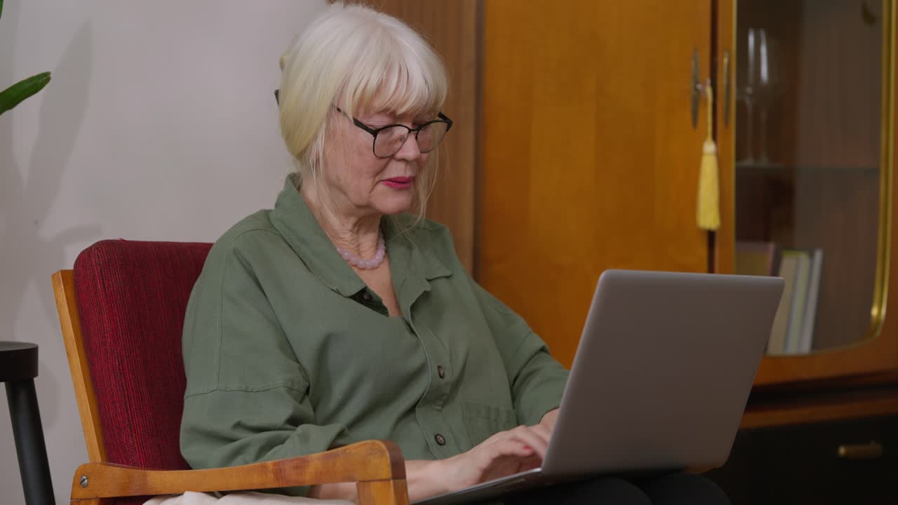 Senior woman using laptop at home