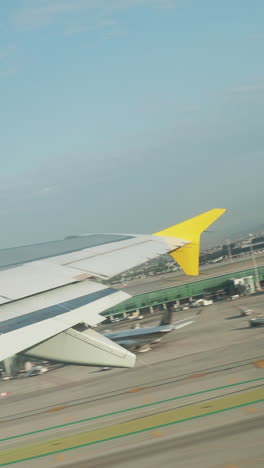 view from a plane window during takeoff from airport in shot in vertical