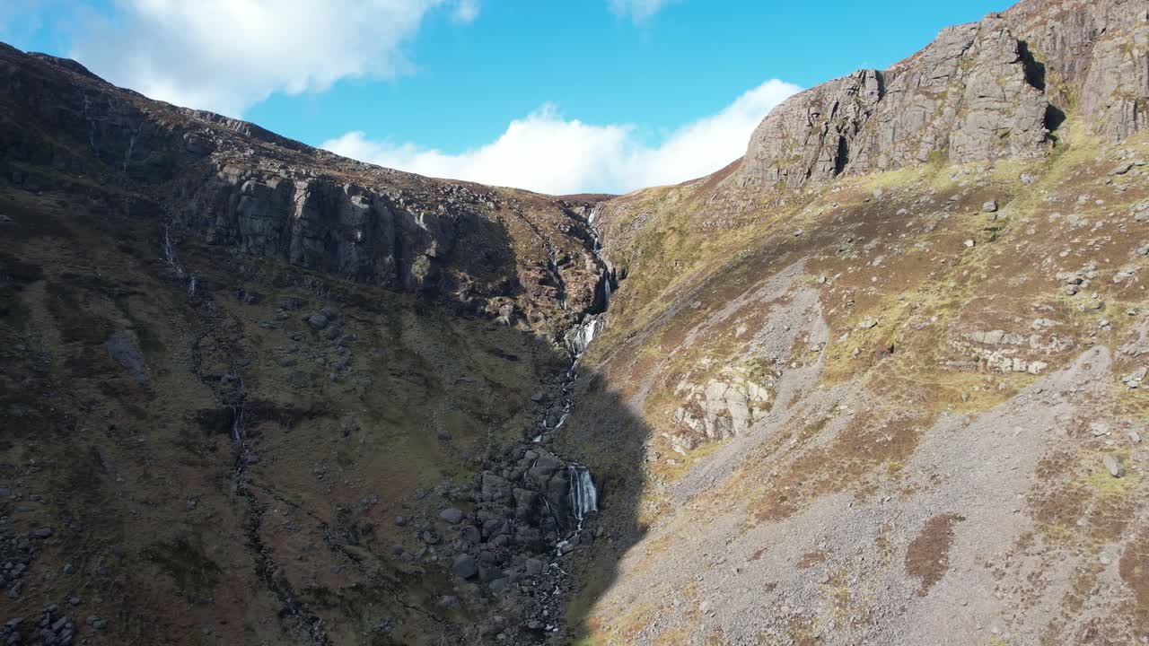 Drone flying slowly to stunning Mahon Falls Comeragh Mountains Waterford Ireland in winter