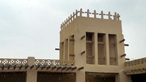 cloudy weather rain shower in tropical climate and the cross design traditional architectural elements symbol on minimal nude color bohemian architecture building qeshm island landscape people culture