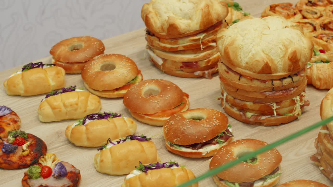 Table filled with savory pastries and bread showcasing a variety of toppings and fillings.