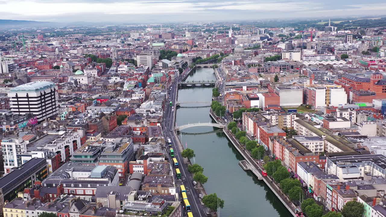 A bright day overlooking Dublin city’s skyline and the areas beyond. The flyover shows the river Liffey below with the sky half covered in clouds.