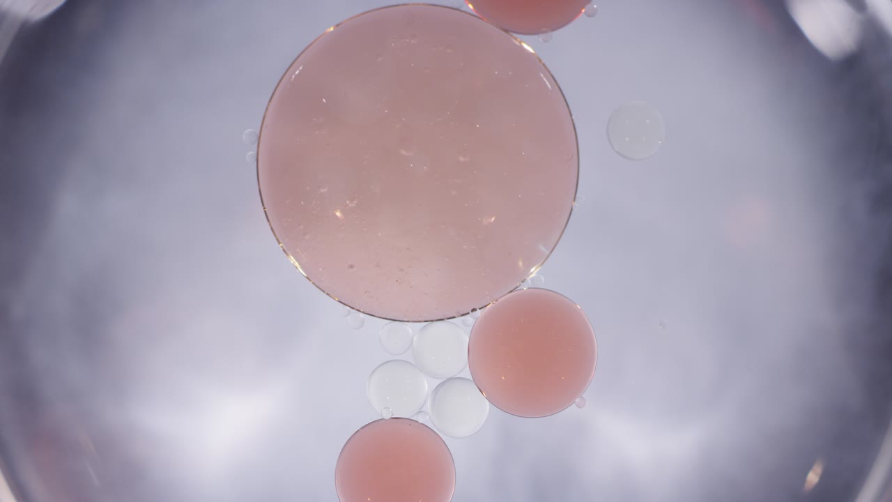 Macro abstract peach and clear liquid cells merging texture background