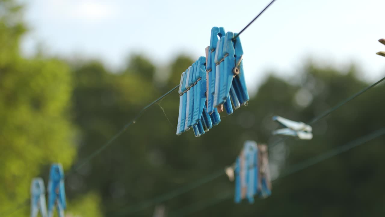 Macro Shot of a Clothespins Lined Up on the Clothesline