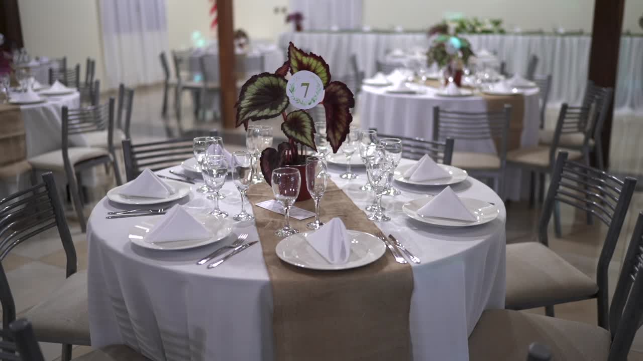 Elegant wedding dinner table setup with folded napkins and floral centerpiece