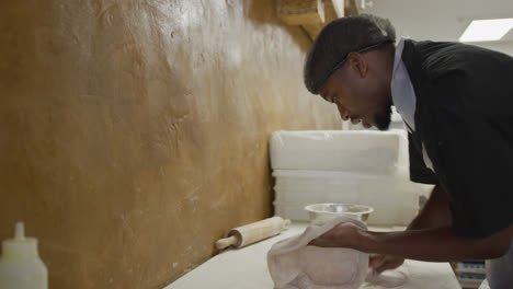 Mixed-race-man-making-a-pizza-dough