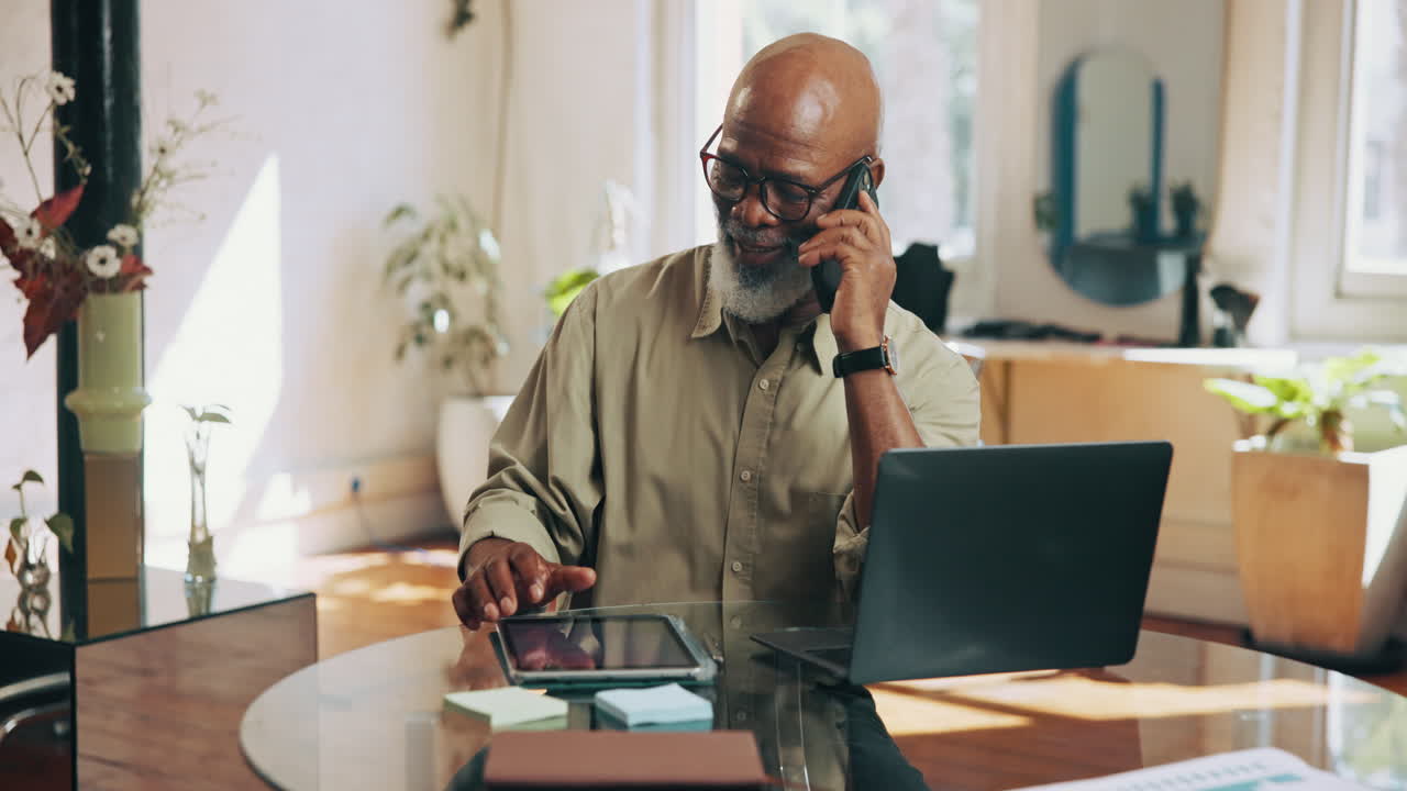 Senior African American Man Talking on Phone and Using Tablet