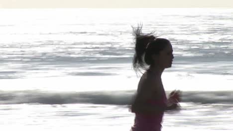 woman on beach jogging