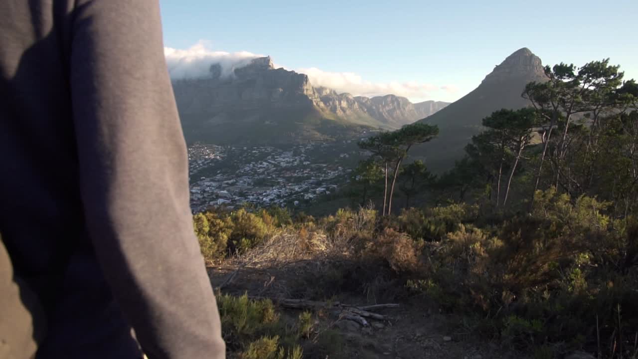 Man walking at Signal Hill towards Table Mountain in Cape Town in Slow Motion